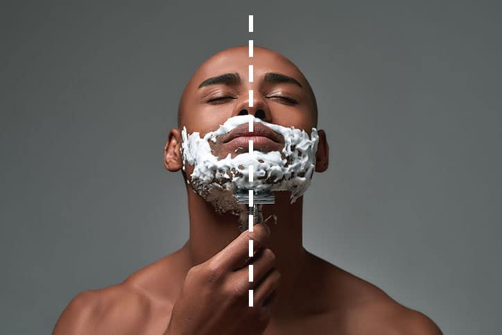 A bald African American man with eyes closed shaving his neck with a safety razor; a vertical dashed white line divides the image